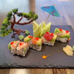 Visit Winona Miya Japanese bistro creates a beautiful sushi display with a faux tree and sculptural details on a slab of granite