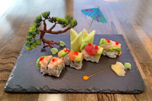 Visit Winona Miya Japanese bistro creates a beautiful sushi display with a faux tree and sculptural details on a slab of granite